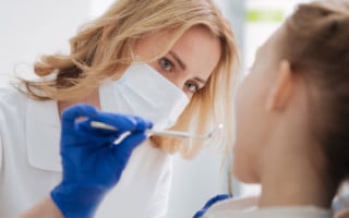 Female dentist giving oral exam