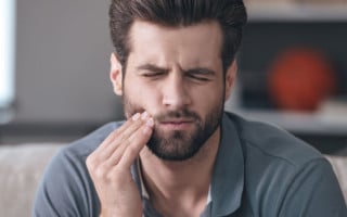 Man with jaw or tooth pain