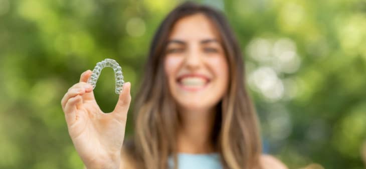 Woman smiling with clear aligner