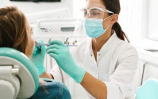 Dentist checking for oral cancer