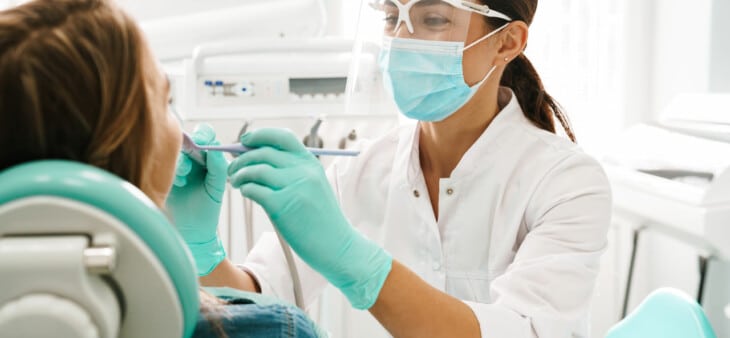 Dentist checking for oral cancer